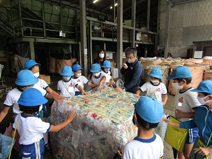 圧縮されたプラスチックごみのかたまりを見ているところです。